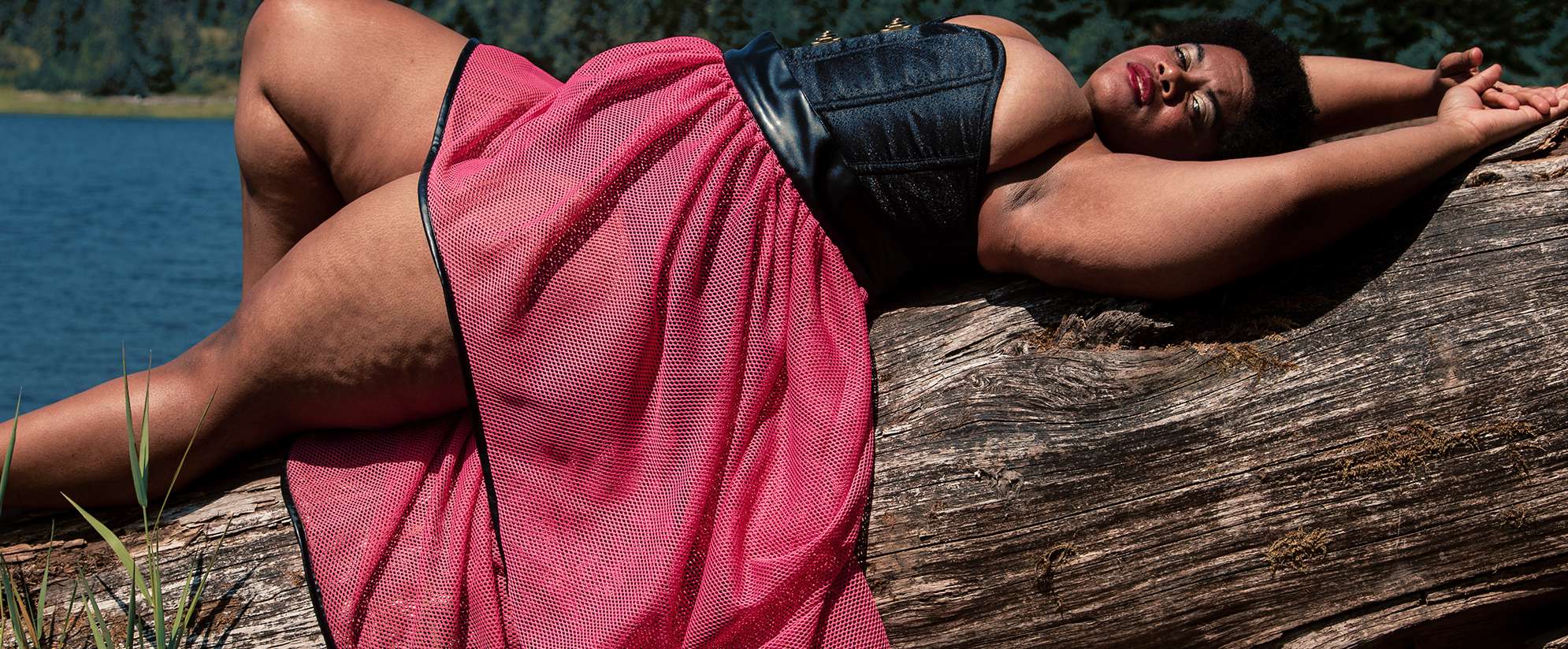 Woman in black corset and pink skirt lying a1